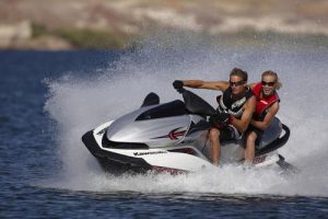 Couple riding jet ski